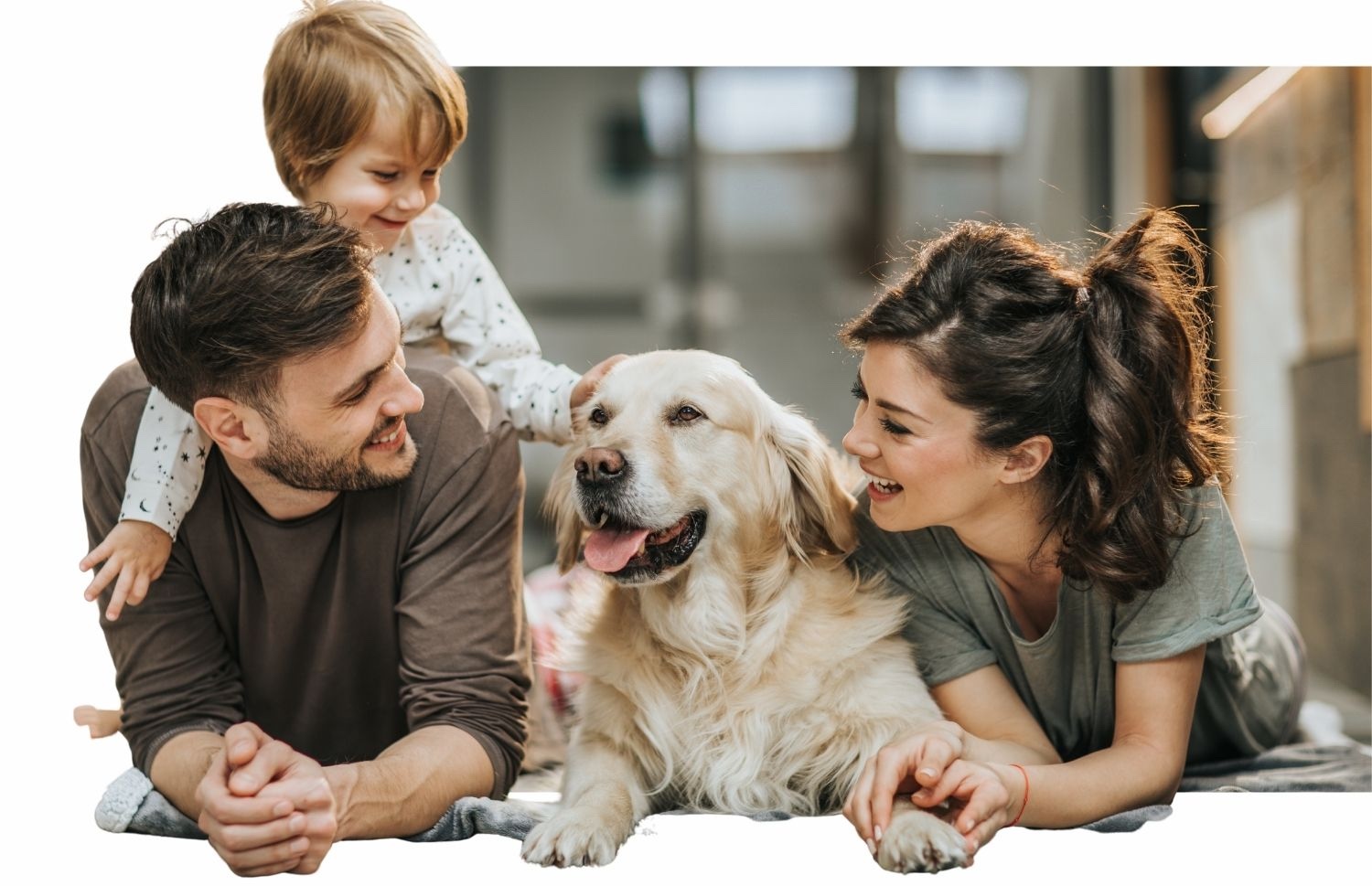 A family and their dog lying on the floor of a bright living room